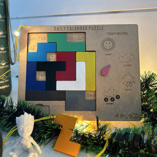 A wooden daily calendar puzzle board with colorful interlocking puzzle pieces and weather icons, styled with green garland and warm string lights.