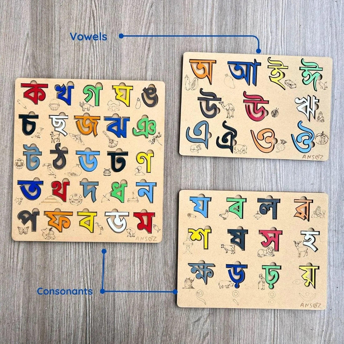 A wooden educational toy set for learning Devanagari script, showing three puzzle boards labeled 'Vowels', 'Consonants', and an unlabeled board on a gray wood-textured background.