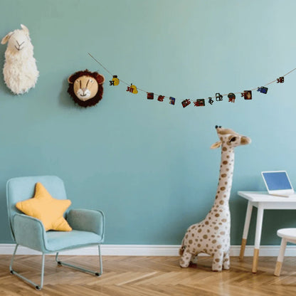 A styled children's room corner with a light blue wall, wooden floor, a light blue armchair with a yellow star pillow, a white giraffe plush toy, a white sheep plush wall hanging, and a colorful animal banner strung across the wall.