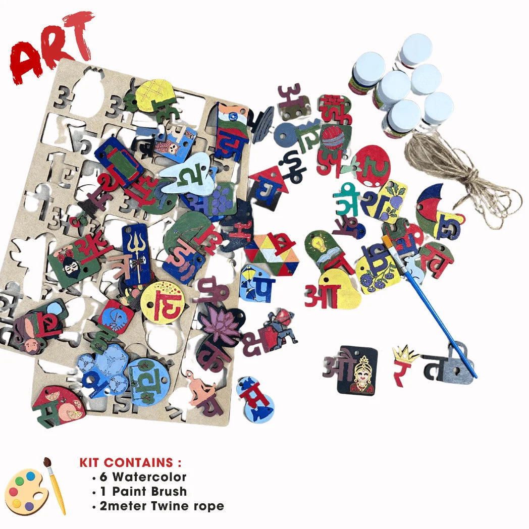 A children's art and craft kit laid out on a white background, including a wooden alphabet puzzle board, colorful painted letter cutouts, small paint bottles, a paintbrush, twine, and a small figurine. Text on the image lists kit contents: 6 watercolor paints, 1 paint brush, and 2 meter twine rope.