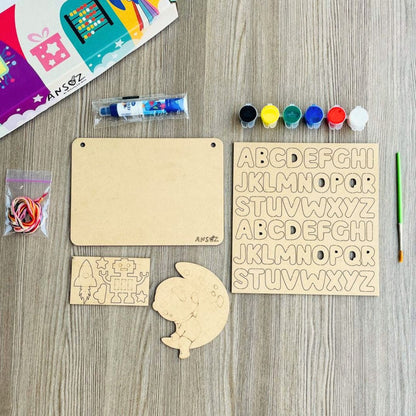 Wooden alphabet letters, paint bottles, and other craft supplies on a wooden surface