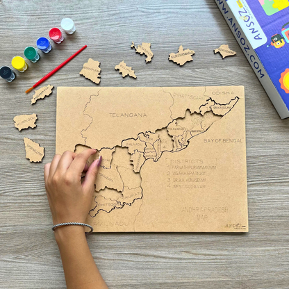 Kid assembling an Andhra Pradesh map puzzle piece, a wooden educational toy with paint set alongside.