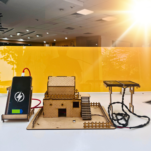 Solar mobile charger kit showing complete setup with solar panel, charging module, wooden model, gaining energy from the sun and charging mobile.