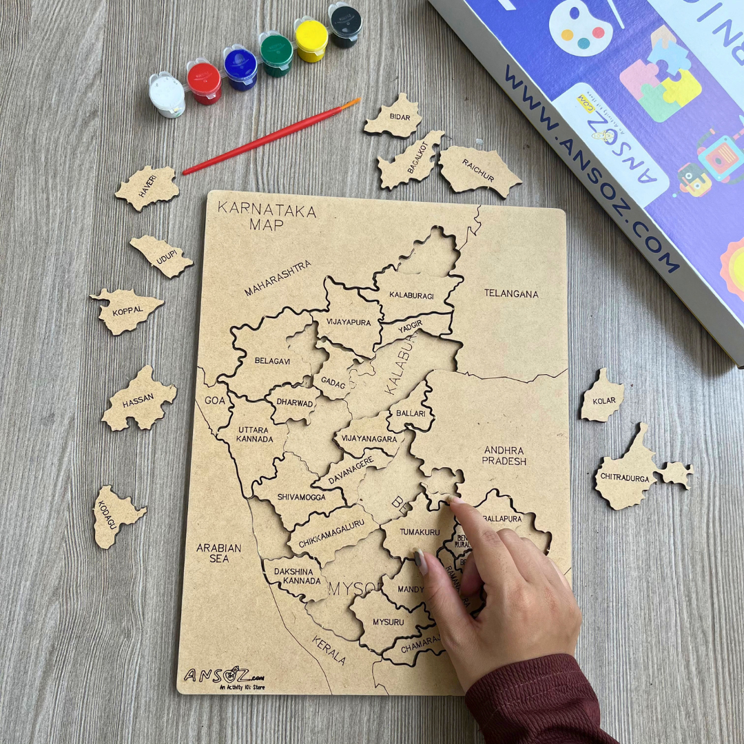Kid placing district pieces on Karnataka map puzzle board, part of an educational puzzle kit with paints