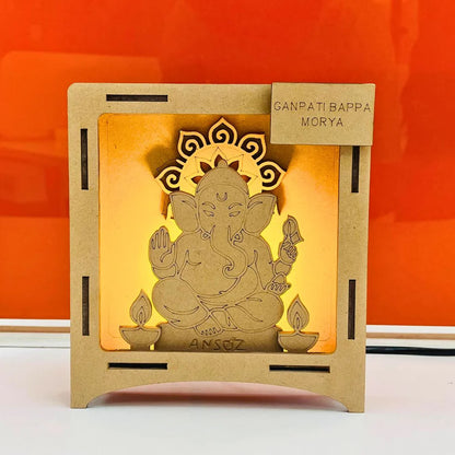 Unpainted wooden Ganesha LED frame with Ganpati Bappa Morya nameplate, a spiritual gift idea for Ganesh Chaturthi decoration.