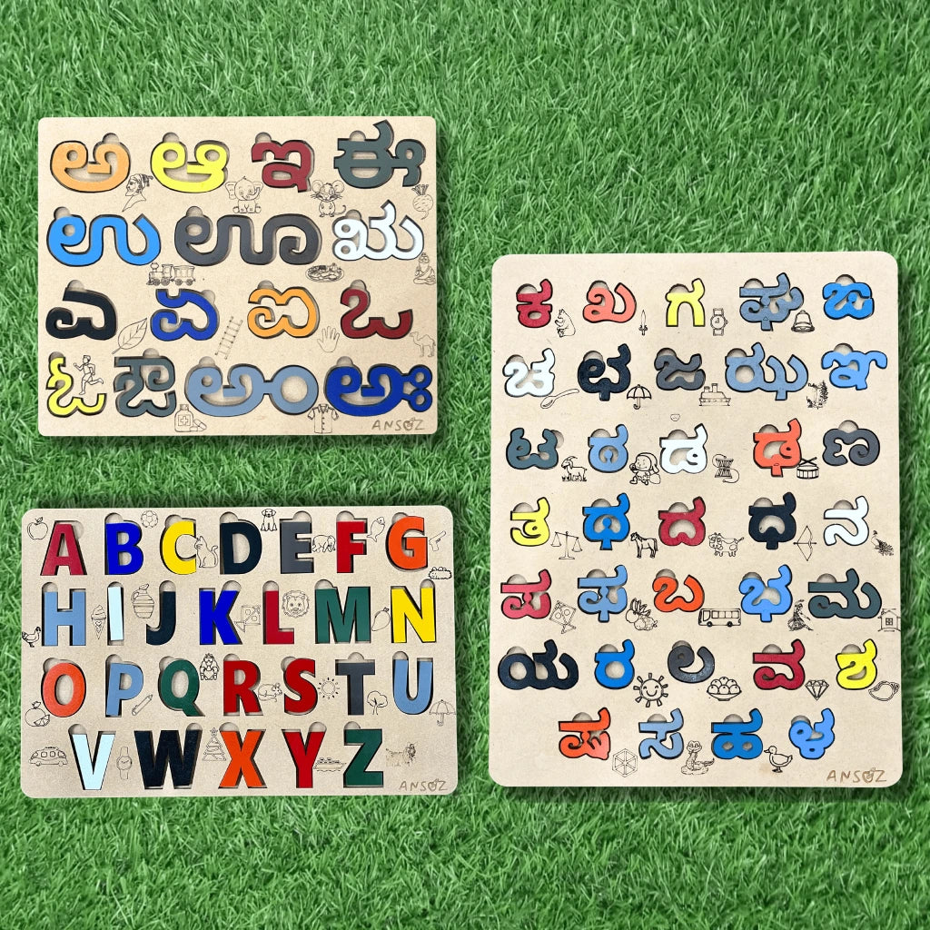 Three wooden alphabet learning boards arranged on green artificial grass. Two boards show uppercase and lowercase letters in Latin script, and the third board shows letters in Telugu script, each with colorful movable pieces and small illustrations.