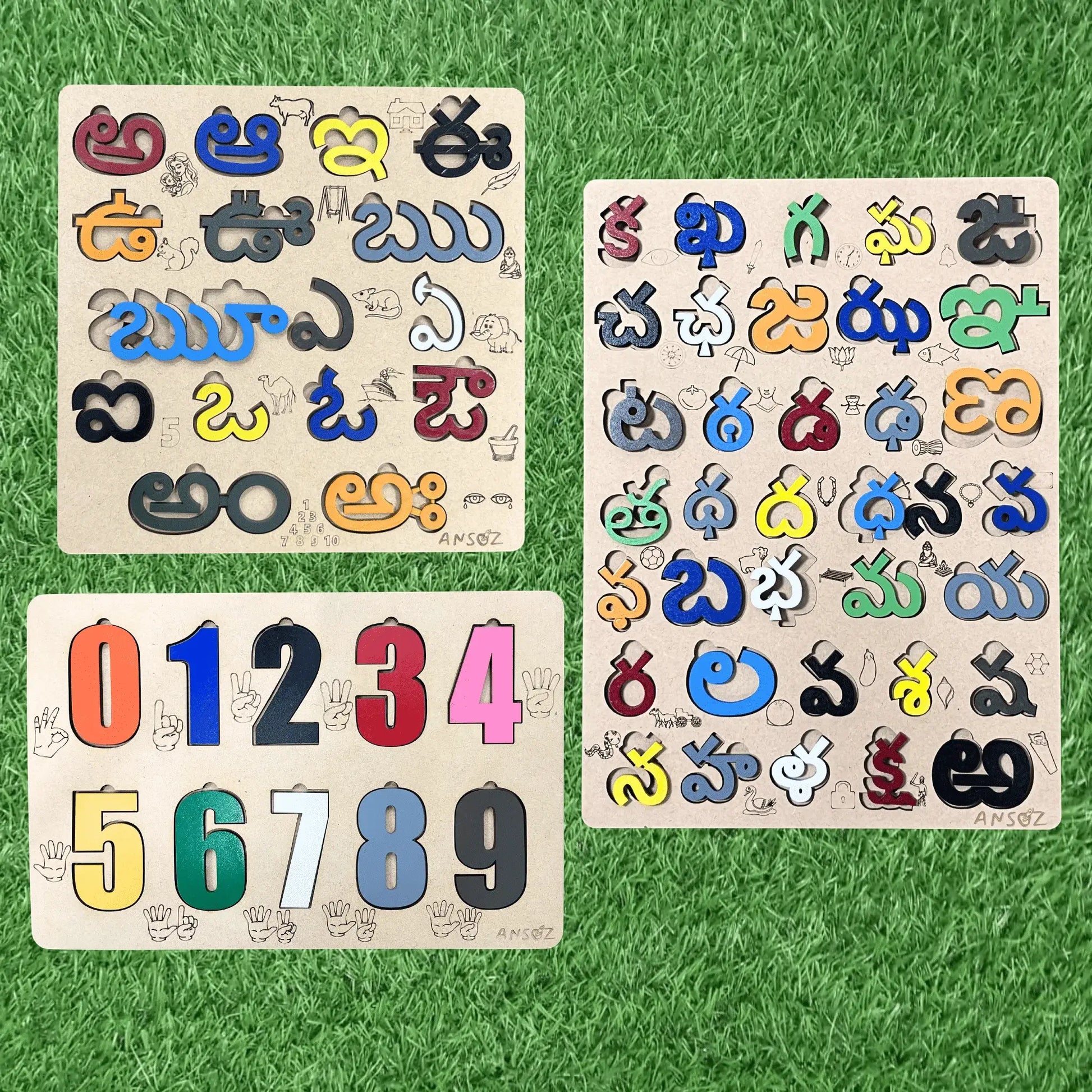 Three wooden children's activity boards with colorful cutout letters and numbers, arranged on a green grass-like surface.