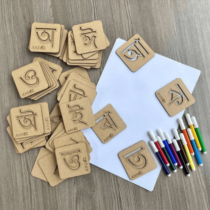Complete Assamese alphabet stencil kit featuring wooden vowel and consonant stencils, drawing sheets, and colorful markers for preschool and kindergarten learning activities.