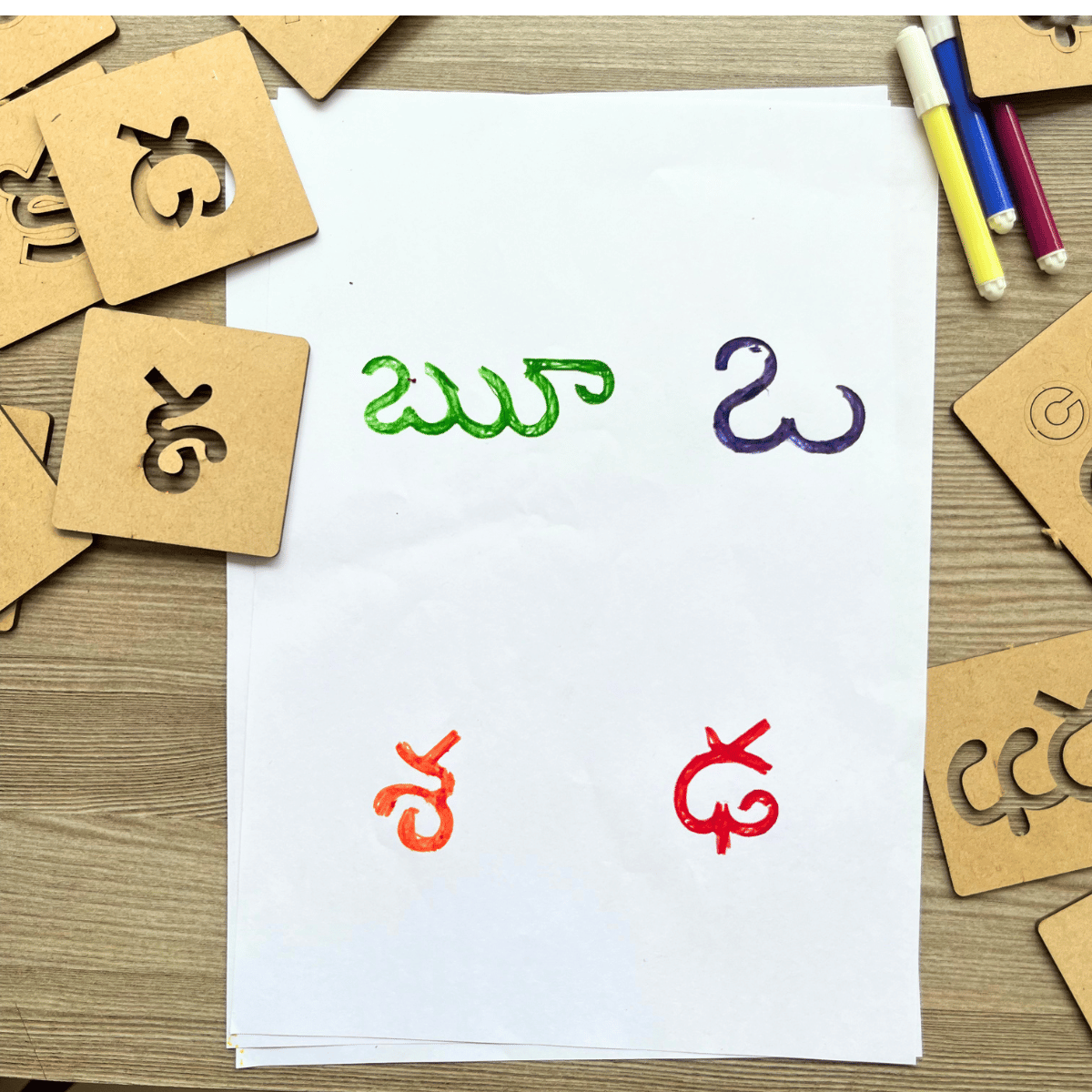 Colorful traced Telugu letters made using alphabet stencils