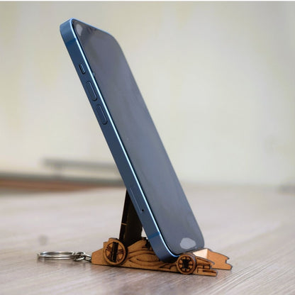  DIY Formula Racing Car Mobile Stand and Keychain Kit holding a smartphone, wooden craft model assembled by kids for creative learning and fun.