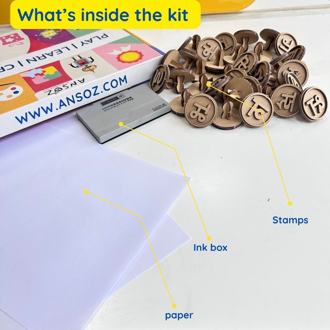 Contents of the Hindi Vowel and Consonant Stamp Kit displayed on a table, including wooden Hindi alphabet stamps, an ink pad, blank sheets of paper, and the packaging box. Everything needed for interactive Hindi language learning is included.