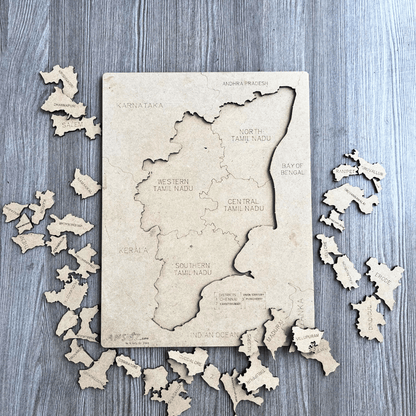 Tamil Nadu district map puzzle board with wooden pieces scattered, north to south regions