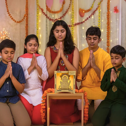 Kids praying with a Ganesha LED lamp, a wooden art and craft idea for Ganesh Chaturthi decoration at home.