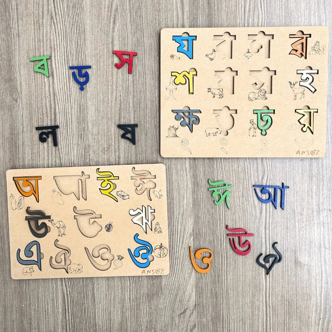 Two wooden Bengali alphabet puzzle boards with colorful movable letters, displayed on a gray wood-textured background.