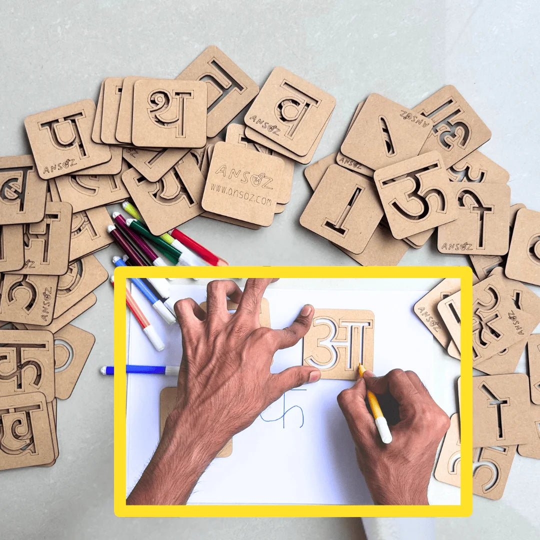A top-down view of wooden number and letter learning cards scattered on a light surface, with an inset photo of hands writing on one of the cards. The cards are natural wood with black cutouts and printed characters.