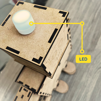 Front view of the fully assembled wooden robot with a clean and modern design. The robot features articulated arms and legs, an illuminated LED headlight, and laser-cut wooden components that fit together to create a sturdy, display-worthy model.