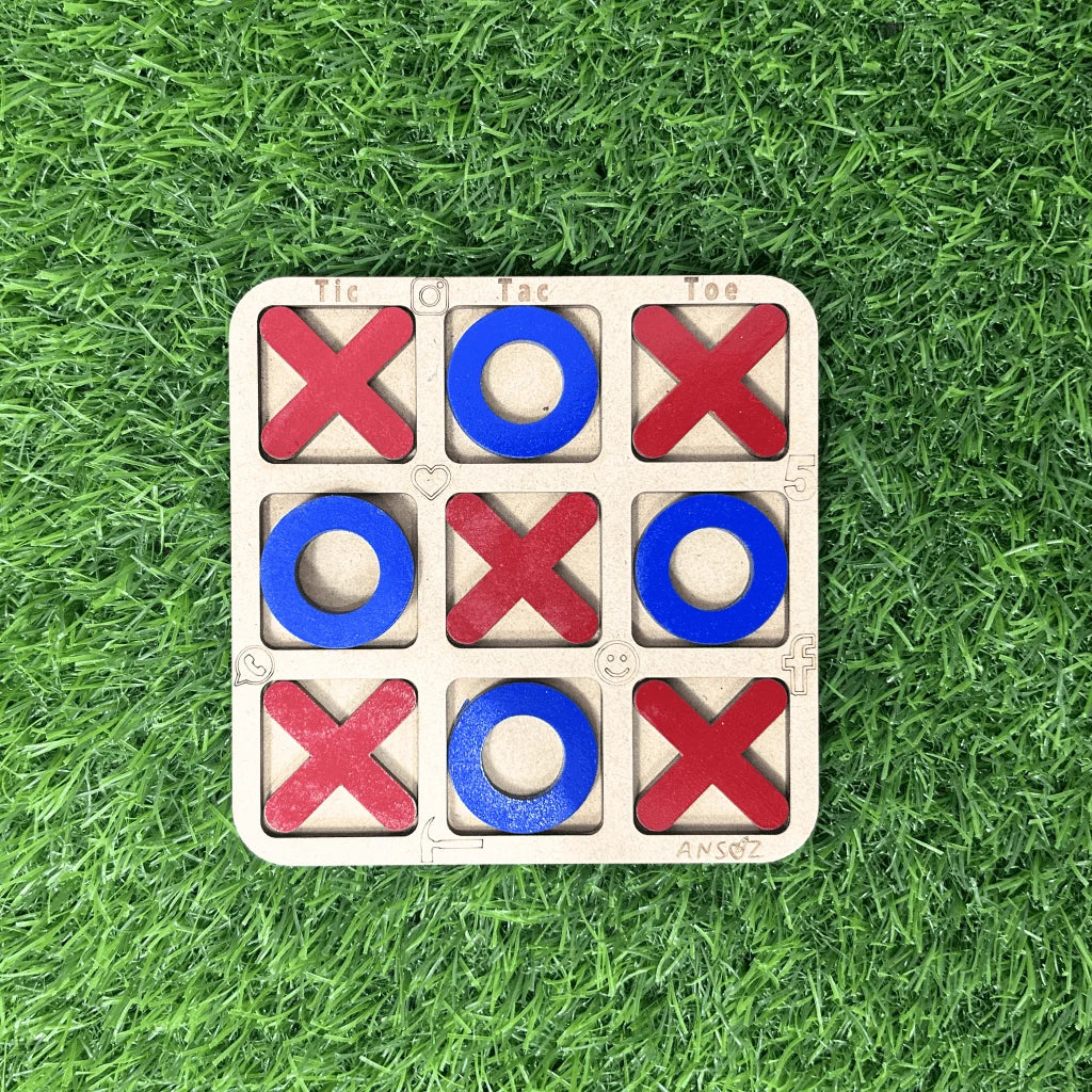 A wooden 3-in-1 tic-tac-toe game board with red Xs and blue Os, placed on a green grass background.